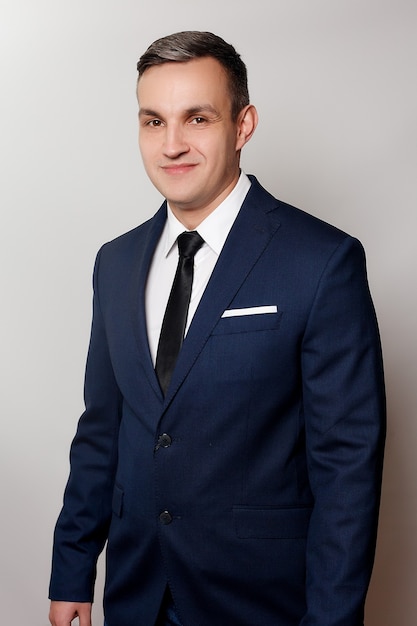 Business, health, people, and lifestyle concept - Portrait of handsome man in black blue suit. close up portrait of young happy smiling cheerful young man