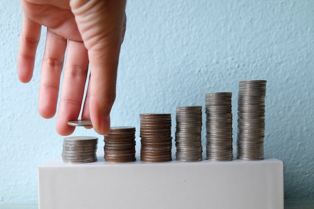 Business idea concept , Hand put coin stacking to money