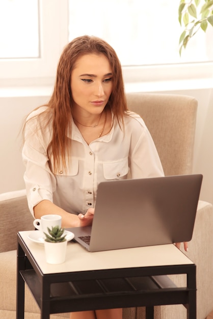 Business lady secretary working on laptop at home