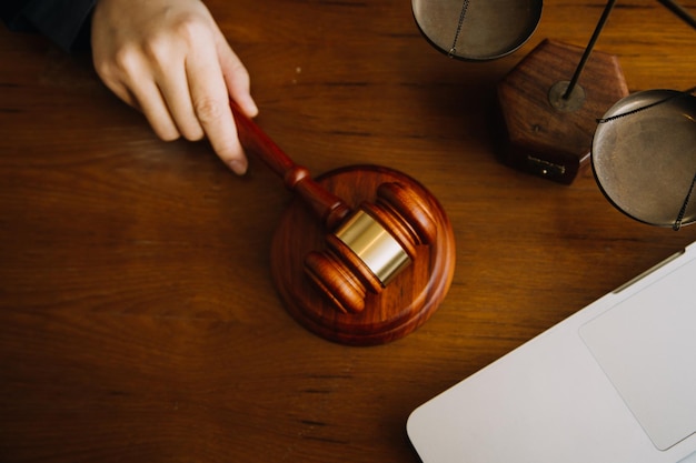 Business and lawyers discussing contract papers with brass scale on desk in office Law legal services advice justice and law concept picture with film grain effect