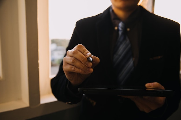 Business and lawyers discussing contract papers with brass scale on desk in office Law legal services advice justice and law concept picture with film grain effect