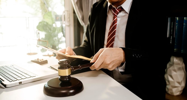 Business and lawyers discussing contract papers with brass scale on desk in office Law legal services advice justice and law concept picture with film grain effect