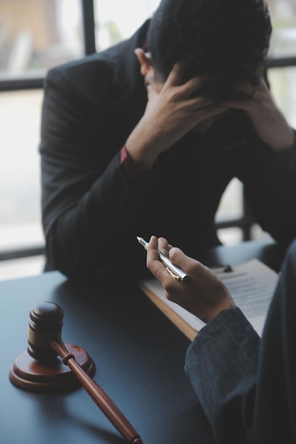 Business and lawyers discussing contract papers with brass scale on desk in office Law legal services advice justice and law concept picture with film grain effect