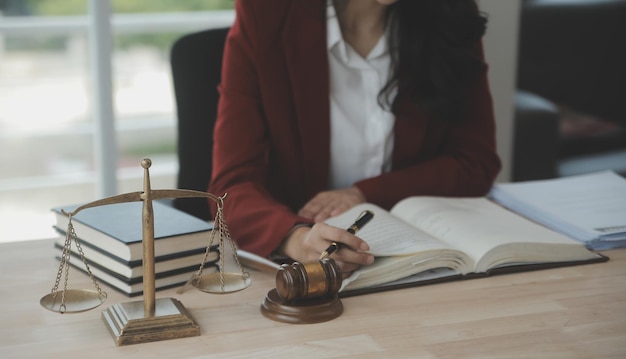 Business and lawyers discussing contract papers with brass scale on desk in office Law legal services advice justice and law concept picture with film grain effect