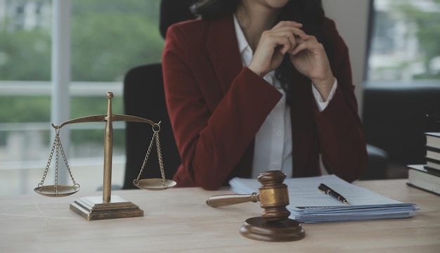 Business and lawyers discussing contract papers with brass scale on desk in office Law legal services advice justice and law concept picture with film grain effect