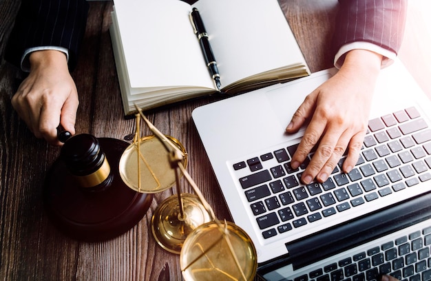 Business and lawyers discussing contract papers with brass scale on desk in office Law legal services advice justice and law concept picture with film grain effect