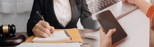 Business and lawyers discussing contract papers with brass scale on desk in office Law legal services advice justice and law concept picture with film grain effect