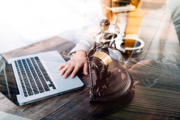 Business and lawyers discussing contract papers with brass scale on desk in office Law legal services advice justice and law concept picture with film grain effect