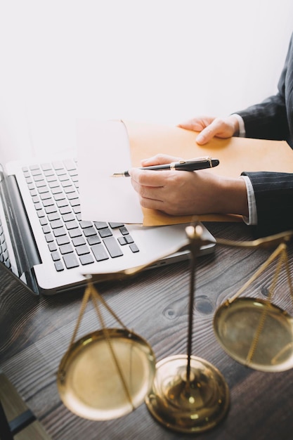 Business and lawyers discussing contract papers with brass scale on desk in office Law legal services advice justice and law concept picture with film grain effect