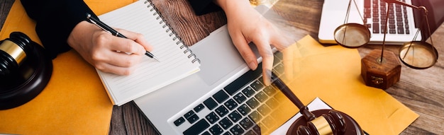 Business and lawyers discussing contract papers with brass scale on desk in office Law legal services advice justice and law concept picture with film grain effect