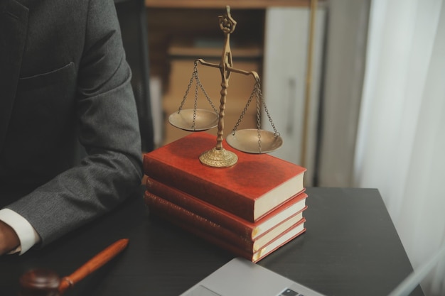 Business and lawyers discussing contract papers with brass scale on desk in office Law legal services advice justice and law concept picture with film grain effect