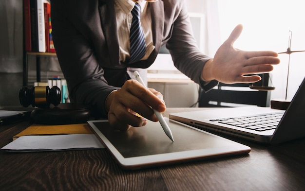 Business and lawyers discussing contract papers with brass scale on desk in office Law legal services advice justice and law concept picture with film grain effect