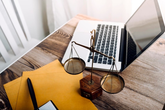 Business and lawyers discussing contract papers with brass scale on desk in office Law legal services advice justice and law concept picture with film grain effect