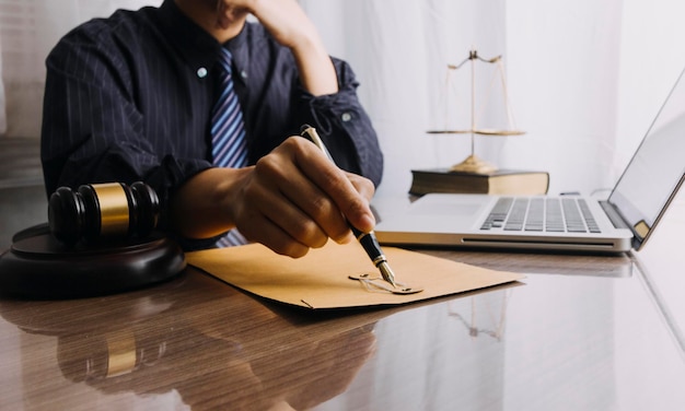 Business and lawyers discussing contract papers with brass scale on desk in office Law legal services advice justice and law concept picture with film grain effect