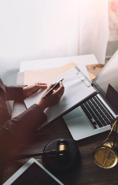 Business and lawyers discussing contract papers with brass scale on desk in office Law legal services advice justice and law concept picture with film grain effect