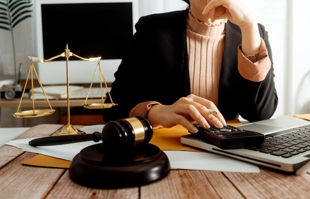 Business and lawyers discussing contract papers with brass scale on desk in office Law legal services advice justice and law concept picture with film grain effect