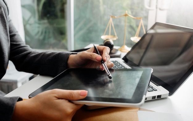 Business and lawyers discussing contract papers with brass scale on desk in office Law legal services advice justice and law concept picture with film grain effect