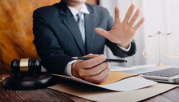 Business and lawyers discussing contract papers with brass scale on desk in office Law legal services advice justice and law concept picture with film grain effect