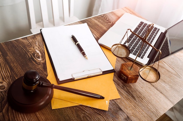 Business and lawyers discussing contract papers with brass scale on desk in office Law legal services advice justice and law concept picture with film grain effect