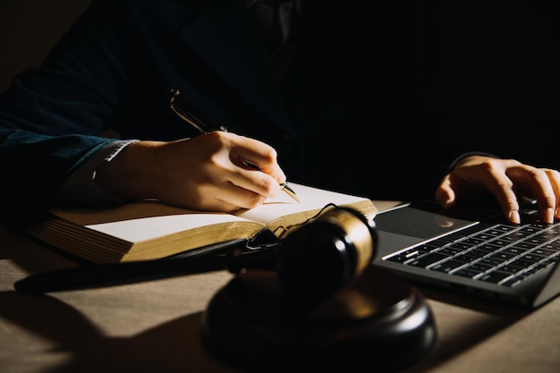 Business and lawyers discussing contract papers with brass scale on desk in office Law legal services advice justice and law concept