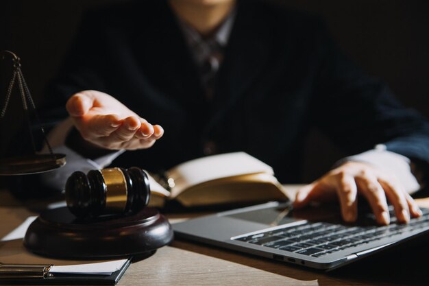 Business and lawyers discussing contract papers with brass scale on desk in office Law legal services advice justice and law concept