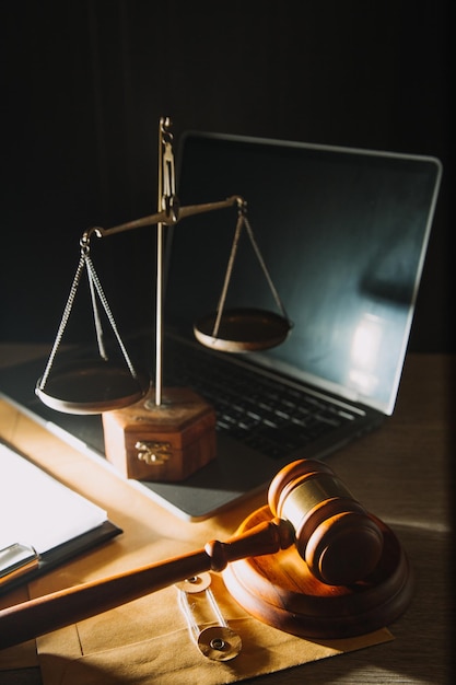 Business and lawyers discussing contract papers with brass scale on desk in office Law legal services advice justice and law concept