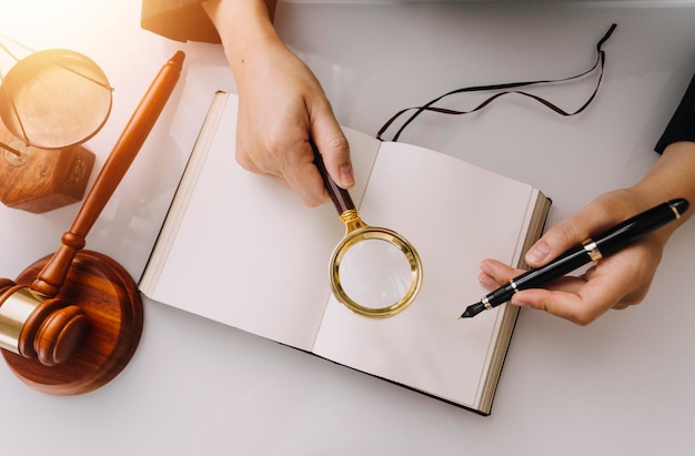 Business and lawyers discussing contract papers with brass scale on desk in office Law legal services advice justice and law concept