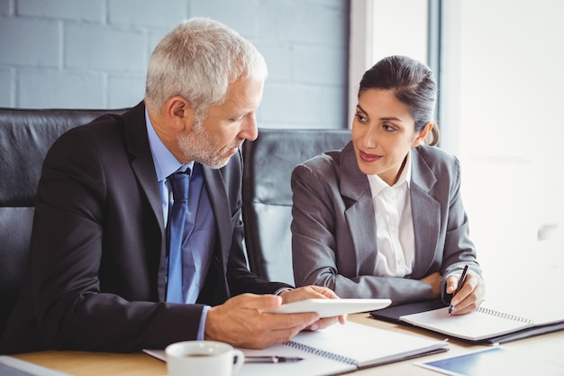 business man and business woman sitting in conference room