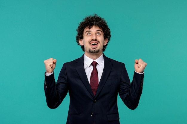 Business man curly cute handsome guy in black suit excited with fists up