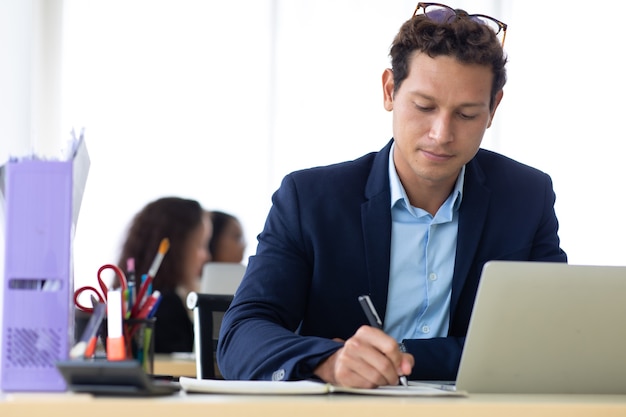 Business Man Entrepreneu working on laptop computer  colleague on background at home office.