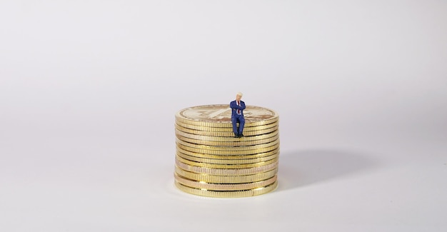 Business man figure sitting on bitcoin Bitcoin mining concept