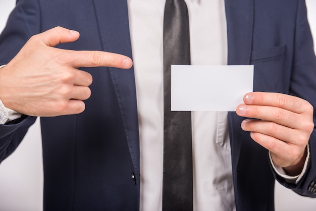 Business man handing a blank business card.