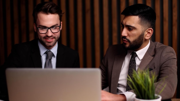 Business man having a discussion with his colleague in an office