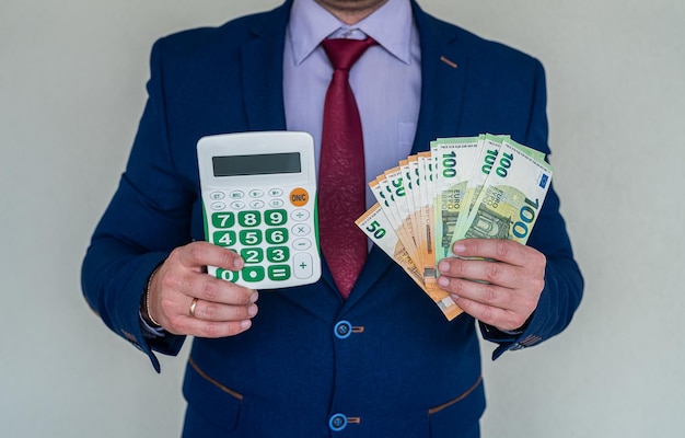 Business man hold euro money and calculator accounting or exchange concept