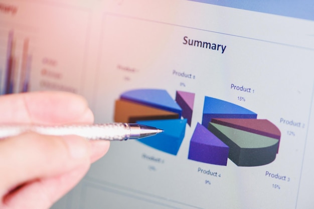 Photo business man holding a pen on diagram graphs business chart summary on screen working in the office business report plan concept