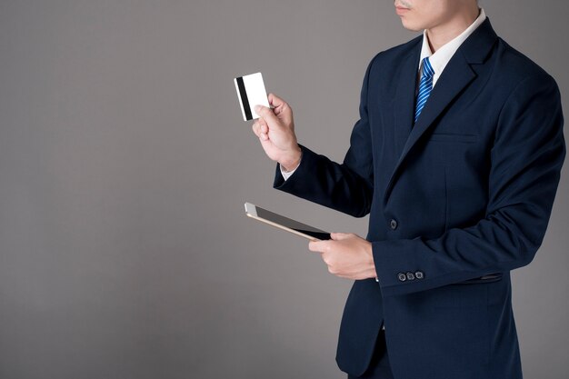 Business man is holding  credit card and tablet, Shopping online concept 