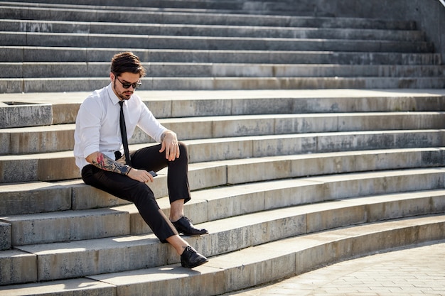 Business man outside using phone