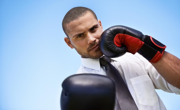 Photo business man portrait and boxing gloves for challenge or warrior self defence and fitness in studio male person strong and equipment for fight or mockup space exercise and blue background