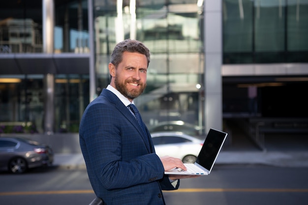 Business man portrait smiling american businessman ceo standing outside office workplace