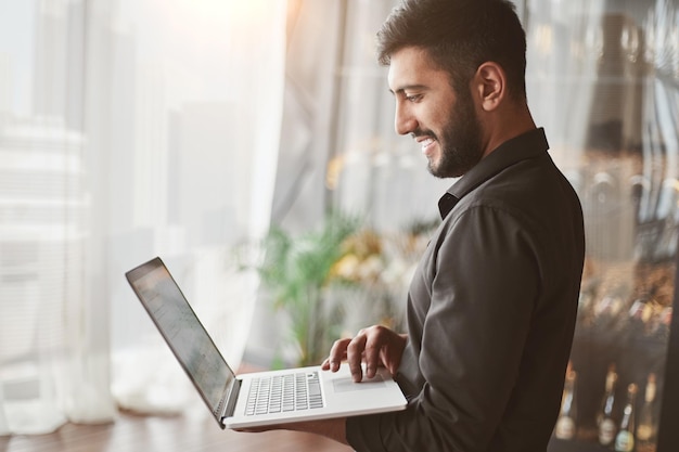 Business man reading an email on his laptop