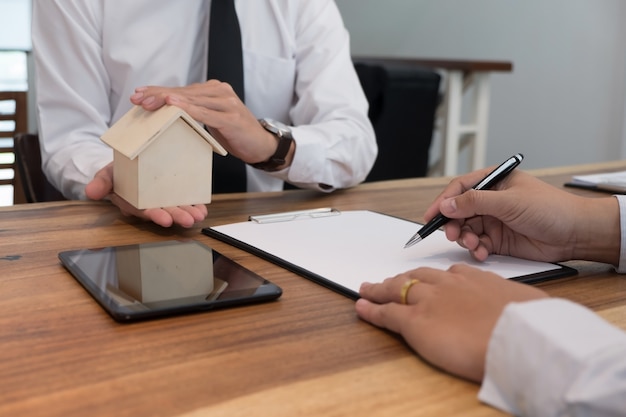 Business man signing contract making a deal with  real estate agent Concept for consultant.