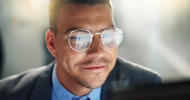 Photo business man and smile on computer in office for positive feedback report on project proposal as market research agent excited male person and digital pc reading email good news and progress