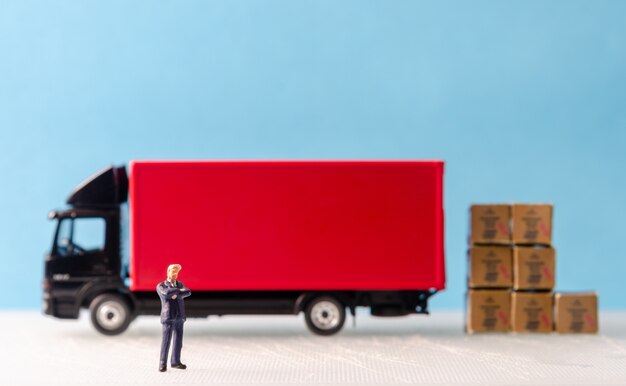 business man standing in front of cargo truck fleet