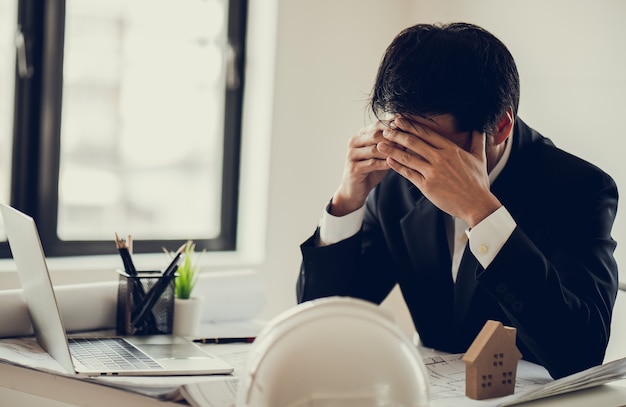 Business man stress and worry about late time to complete of construction project