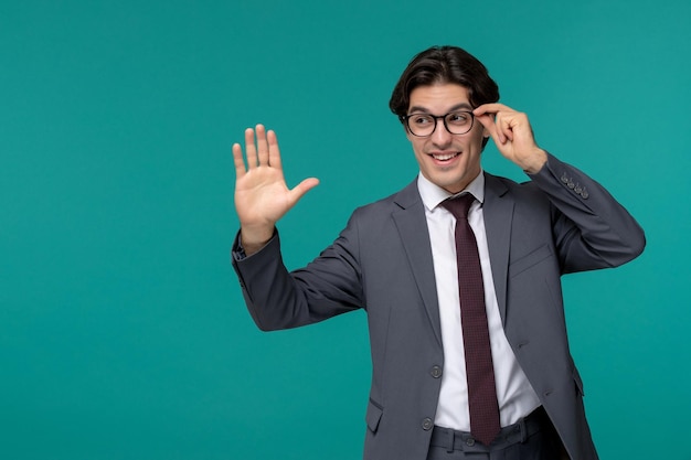 Business man stylish cute handsome man in grey office suit and tie saying hi gesture