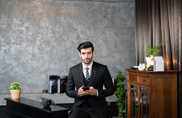 Business man in a suit using smartphone deal a customer and manage order