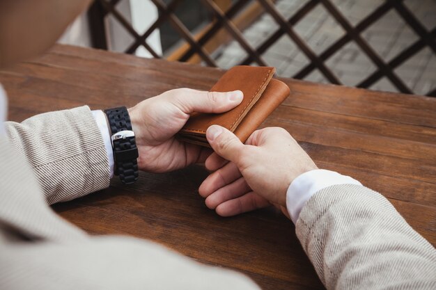 Business man at the table with a wallet