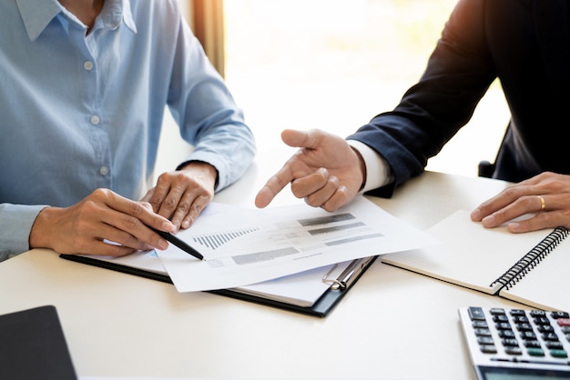 business man and team analyzing financial statement for planning financial customer case in office.