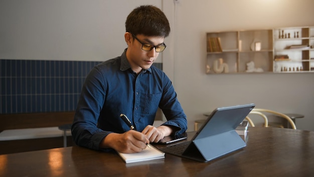 Business man using laptop computer at modern office with blurred backgroundxA