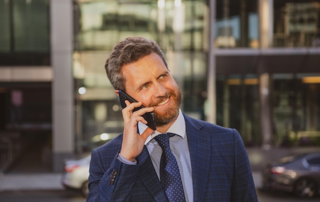 Business man using smartphone. Businessman talking on phone.